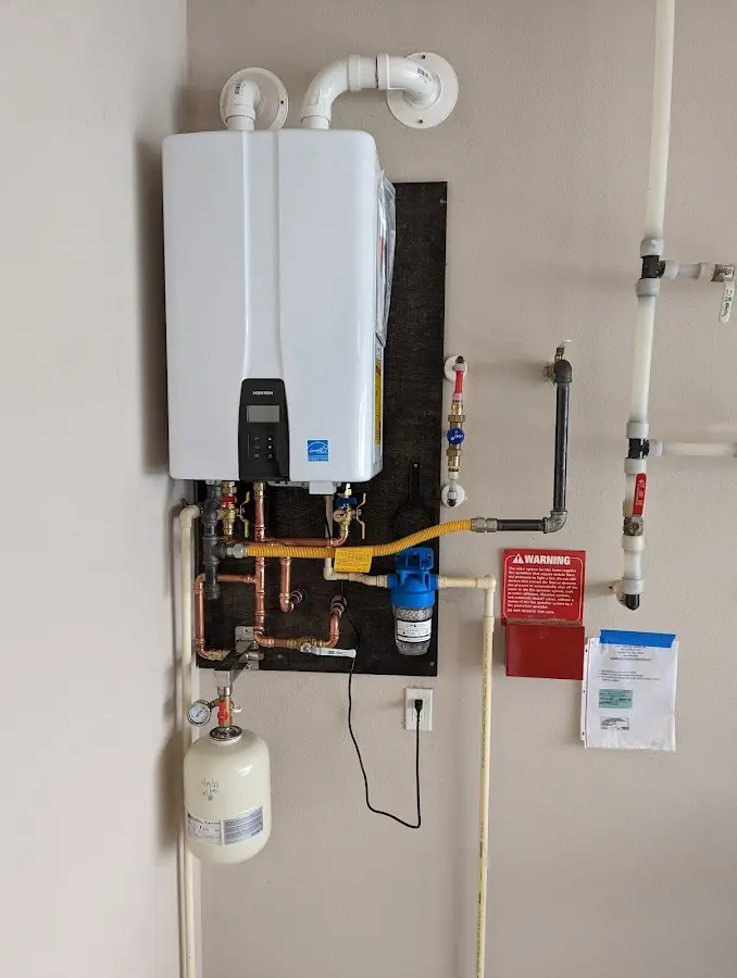 Professional plumber installing copper piping in a Doylestown home